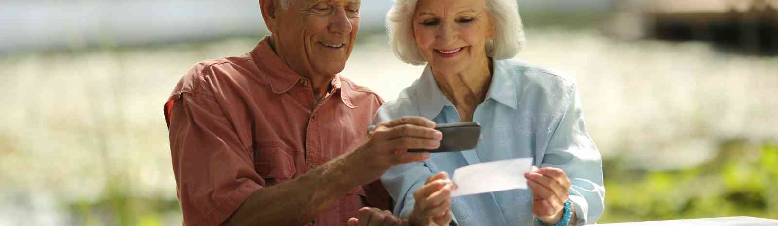Couple using their mobile phone for mobile deposit