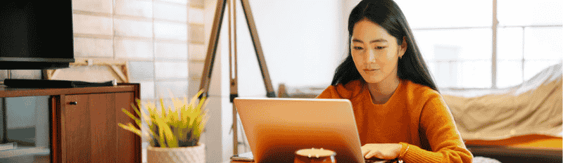 woman in blouse on laptop