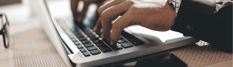 hands typing on a laptop